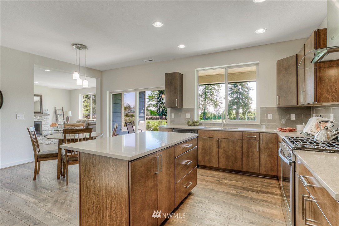 719 Southwest Langston Road Renton, WA 98057 - Photo 4 of 25 a kitchen with kitchen island granite countertop a sink and counter space