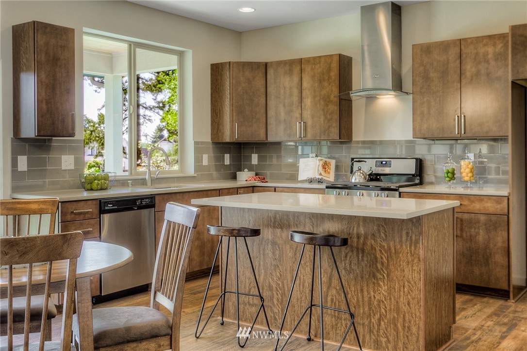 719 Southwest Langston Road Renton, WA 98057 - Photo 7 of 25 a kitchen with a table chairs sink and cabinets