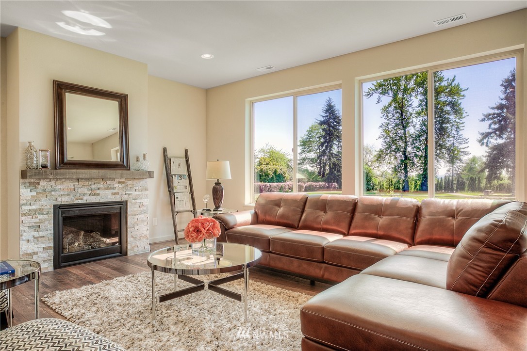 719 Southwest Langston Road Renton, WA 98057 - Photo 10 of 25 a living room with furniture fireplace and a large window