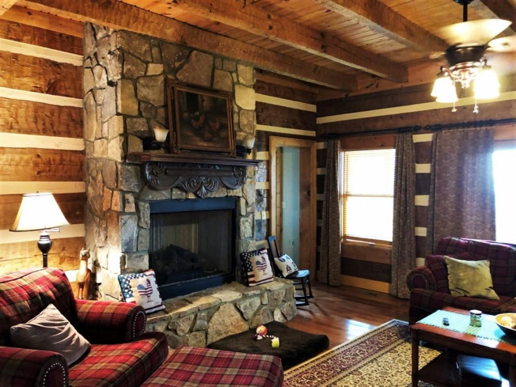Den with wood burning fireplac