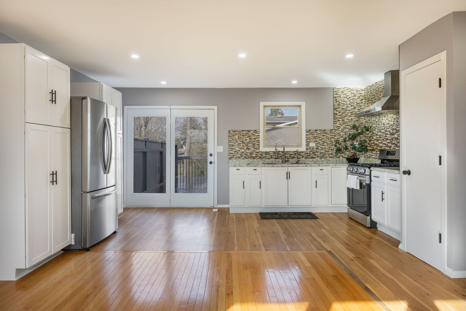 265 Cobb Circle Bolingbrook, IL 60440 - Photo 11 of 29 a kitchen with stainless steel appliances granite countertop a refrigerator a sink and a stove with wooden floor