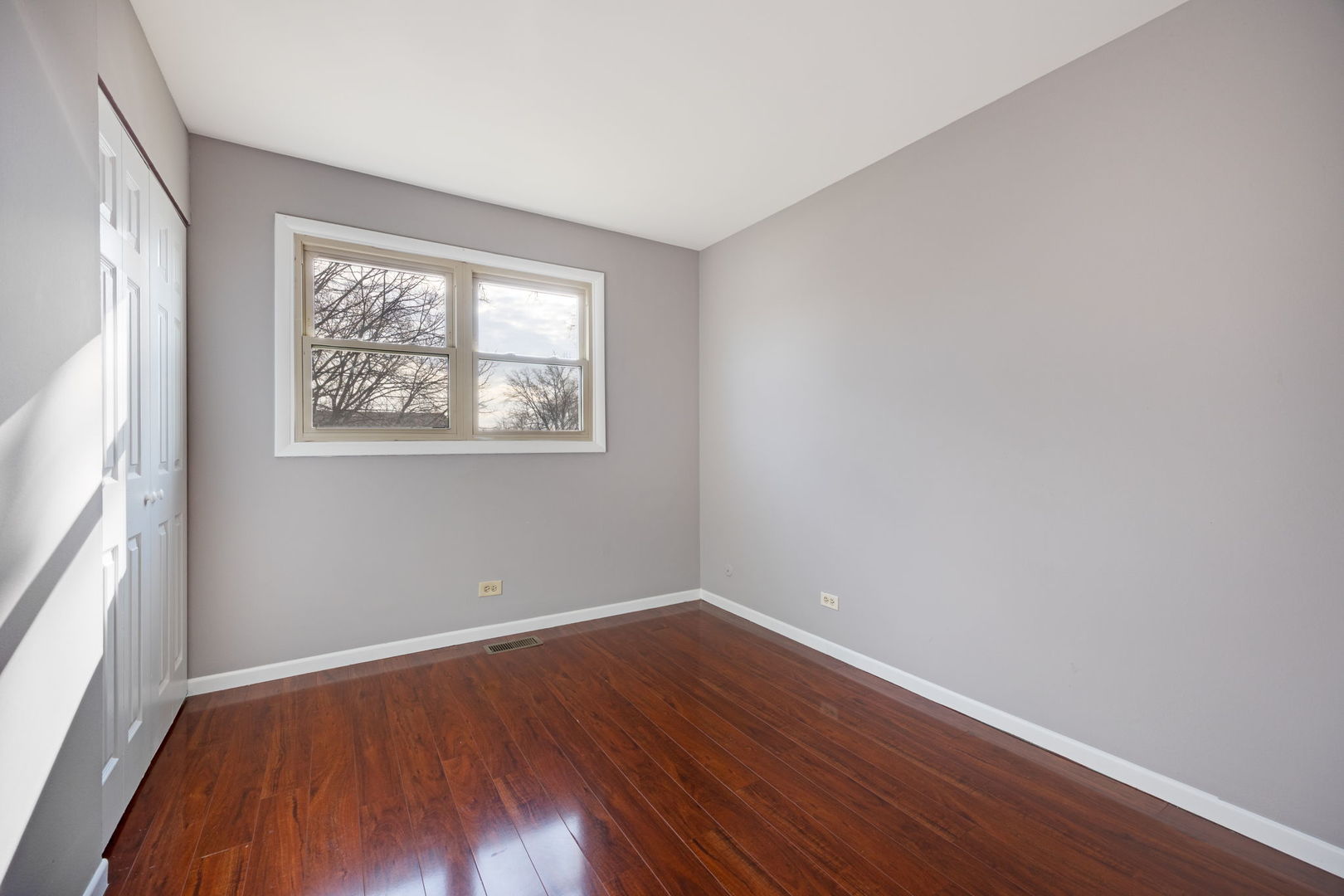 265 Cobb Circle Bolingbrook, IL 60440 - Photo 17 of 29 a view of an empty room with wooden floor and a window
