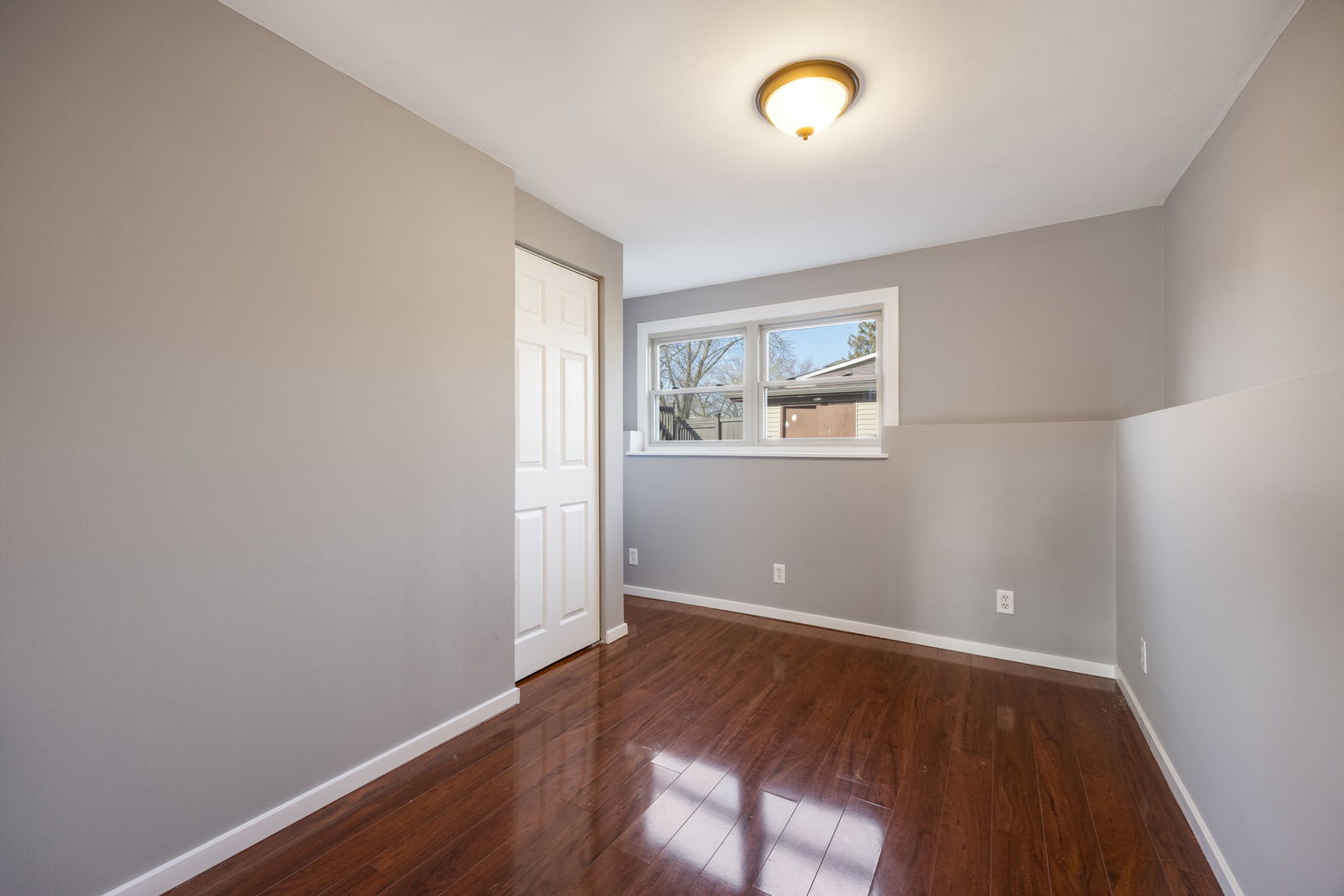 265 Cobb Circle Bolingbrook, IL 60440 - Photo 20 of 29 an empty room with wooden floor and windows