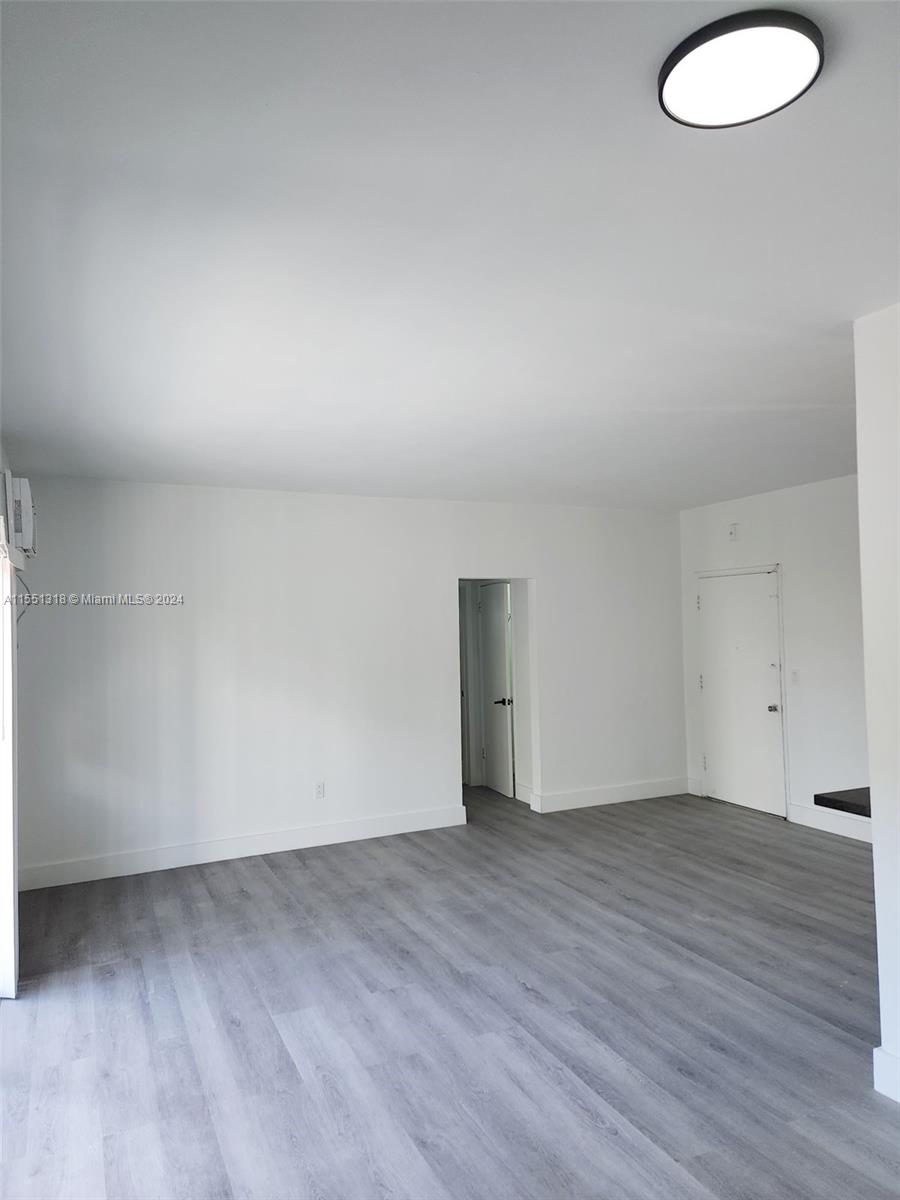 2101 Normandy Drive, Unit 204 Miami Beach, FL 33141 - Photo 11 of 30 a view of an empty room and wooden floor