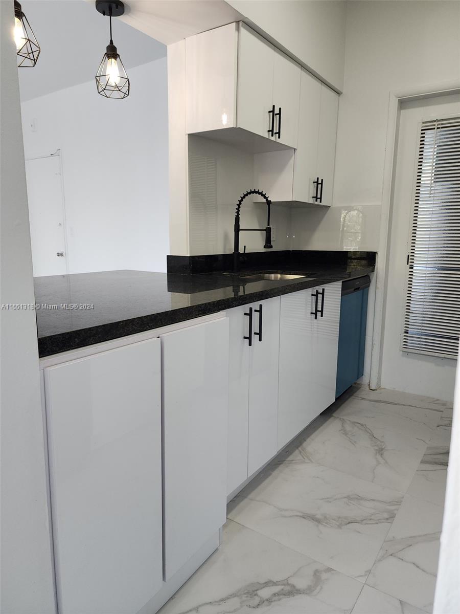 2101 Normandy Drive, Unit 204 Miami Beach, FL 33141 - Photo 17 of 30 a close view of a sink a counter and cabinets