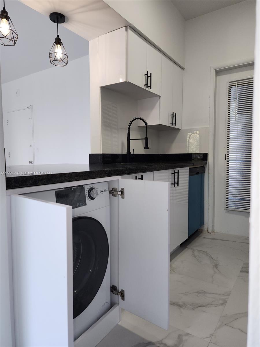 2101 Normandy Drive, Unit 204 Miami Beach, FL 33141 - Photo 18 of 30 a utility room with sink dryer and washer
