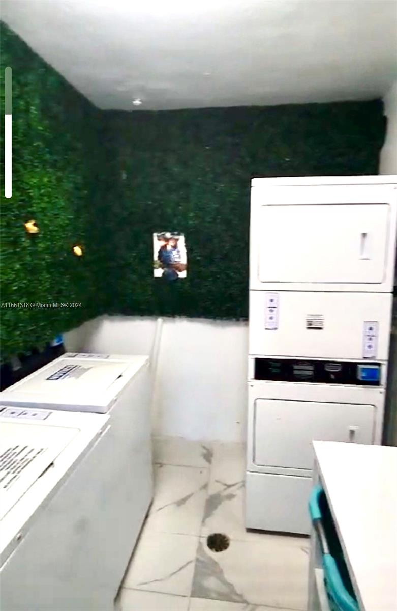 2101 Normandy Drive, Unit 204 Miami Beach, FL 33141 - Photo 29 of 30 a bathroom with a sink and a mirror