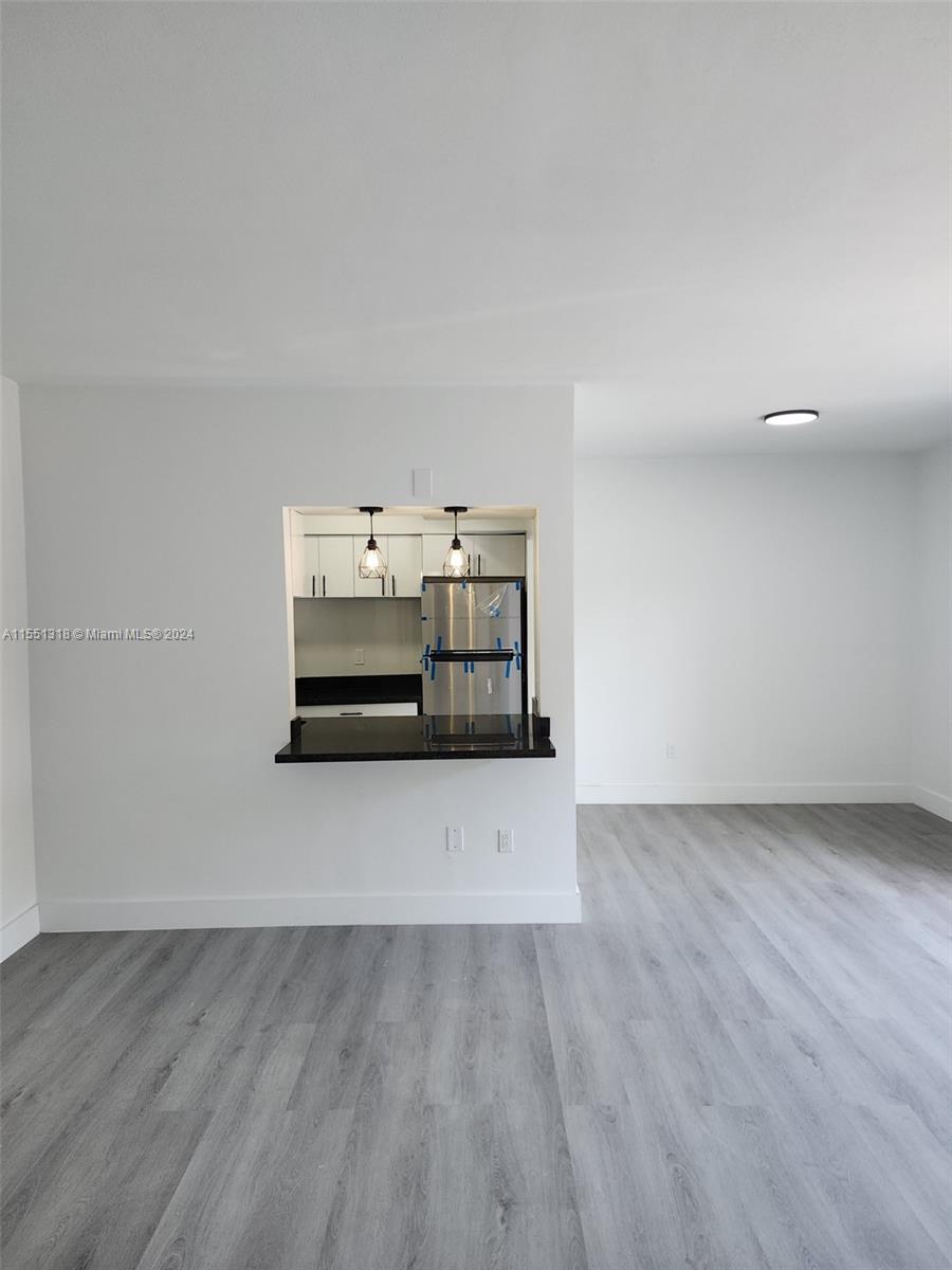 2101 Normandy Drive, Unit 204 Miami Beach, FL 33141 - Photo 9 of 30 a view of a room with a wooden floor