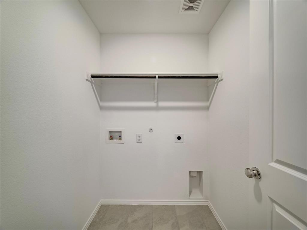 357 Sun Bluff Road Fort Worth, TX 76052 - Photo 17 of 35 Dedicated utility space featuring a built-in shelf with a hanging rod, tile flooring, and essential appliance hookups
