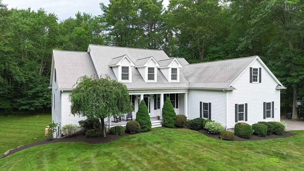 a aerial view of a house with a yard and plants