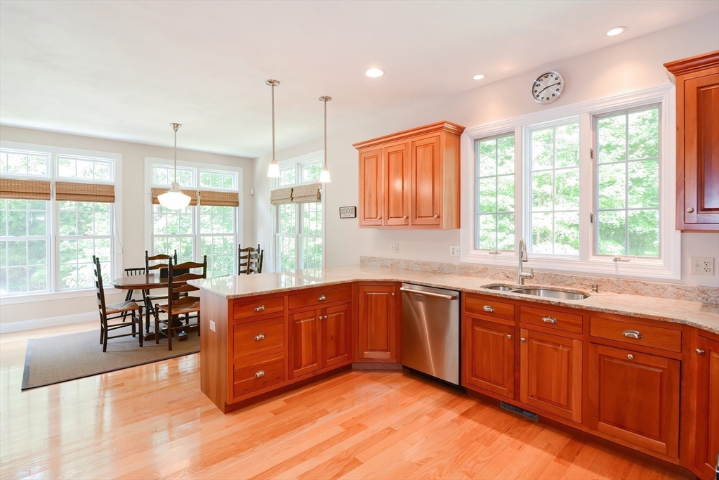 3 Freeman Place Mendon, MA 01756 - Photo 11 of 41 a kitchen with stainless steel appliances granite countertop sink stove and wooden cabinets