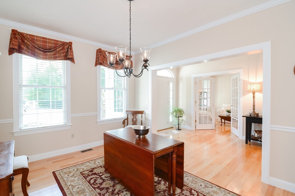 3 Freeman Place Mendon, MA 01756 - Photo 19 of 41 a living room with furniture and a chandelier