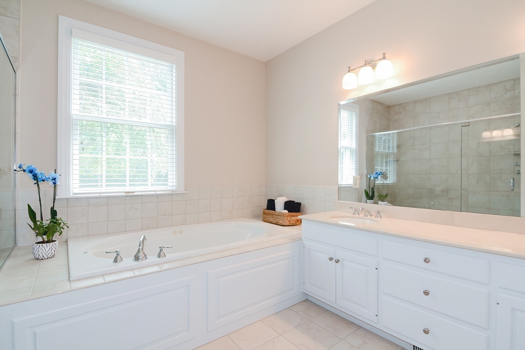 3 Freeman Place Mendon, MA 01756 - Photo 24 of 41 a spacious en suite bathroom with a granite countertop tub and a sink