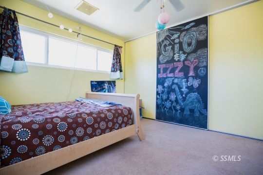 2030 South Inyo Street Ridgecrest, CA 93555 - Photo 29 of 42 a bedroom with a bed and a painting on the wall