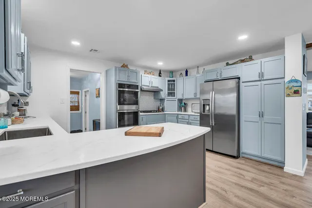 a kitchen with granite countertop a refrigerator and a sink