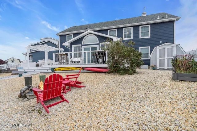a aerial view of a house with swimming pool table and chairs