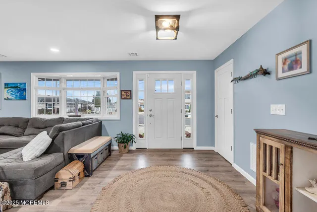 a living room with furniture a fireplace and kitchen view
