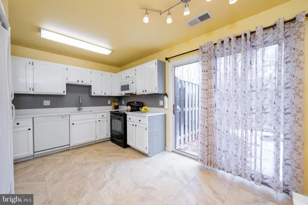 a kitchen with a sink and a stove top oven