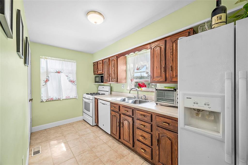 8 Ellen Drive McKees Rocks, PA 15136 - Photo 11 of 25 a kitchen with stainless steel appliances granite countertop a sink and a refrigerator