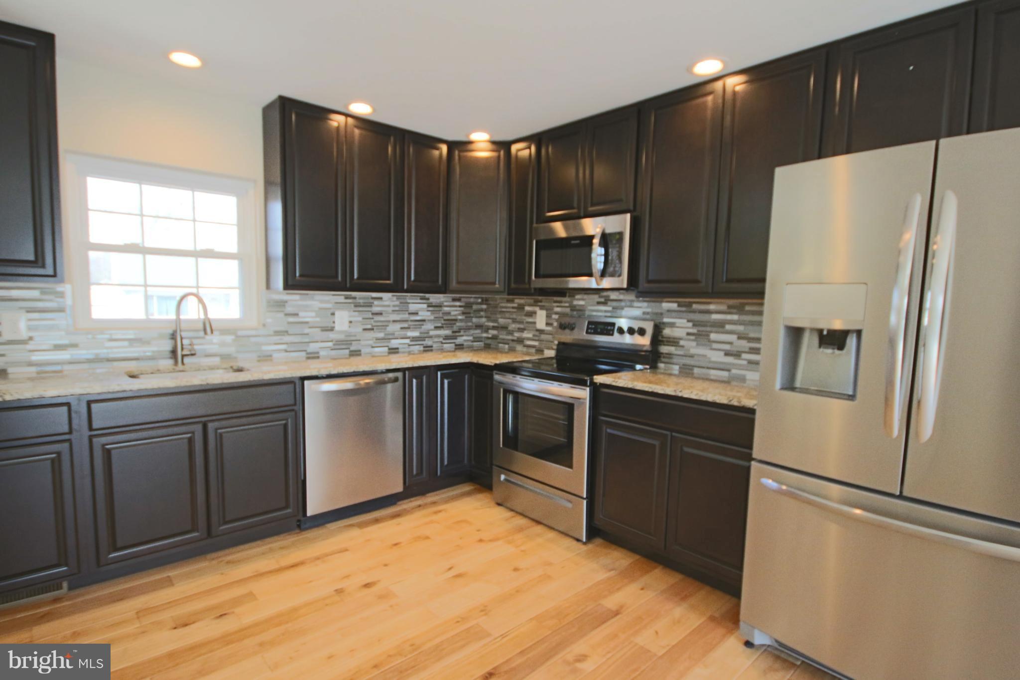 215 Kenwood Road Pasadena, MD 21122 - Photo 3 of 22 Kitchen w/granite counters & ss appliances