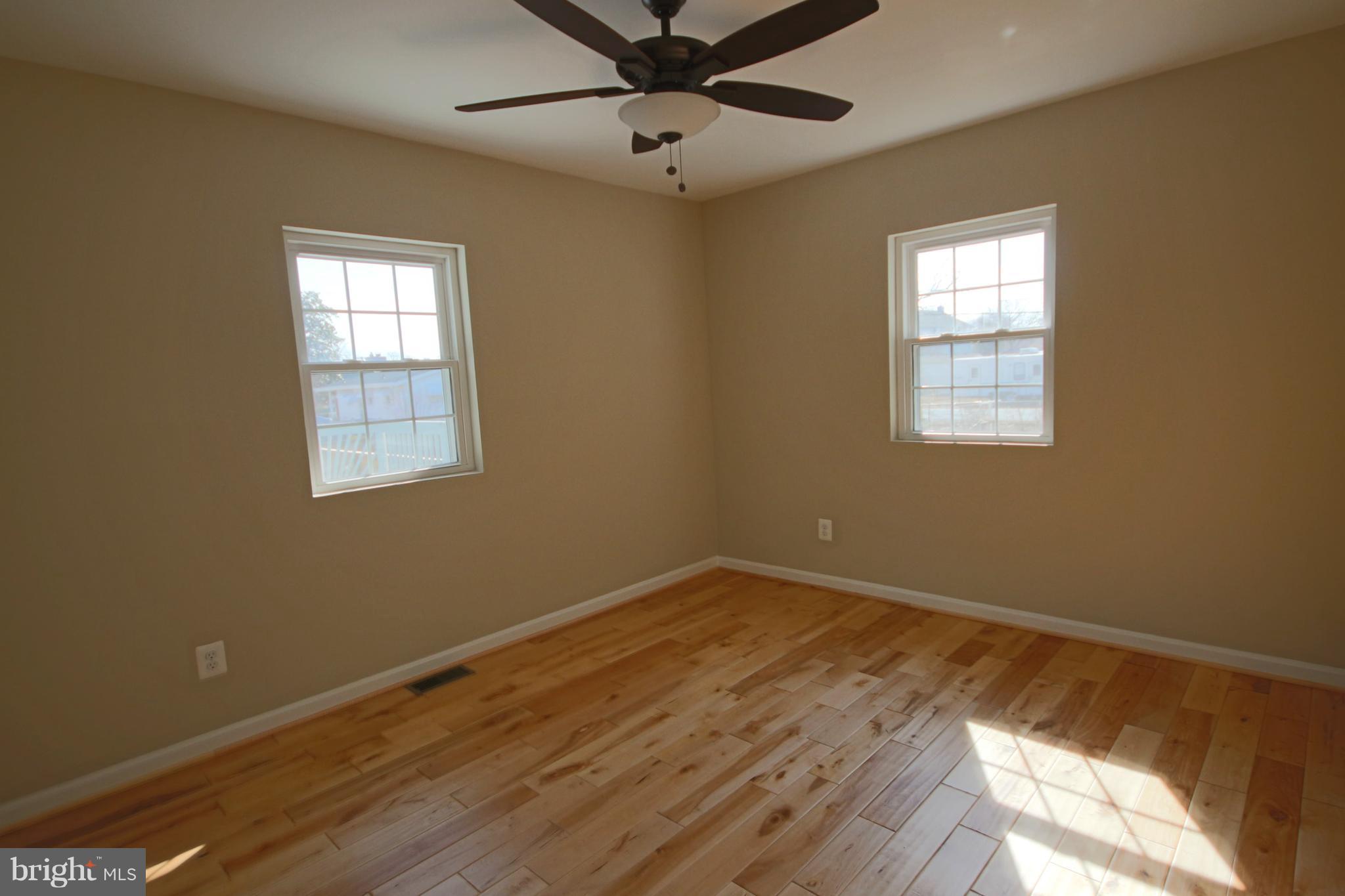 215 Kenwood Road Pasadena, MD 21122 - Photo 6 of 22 Master Bedroom w/wood floors & ceiling fan