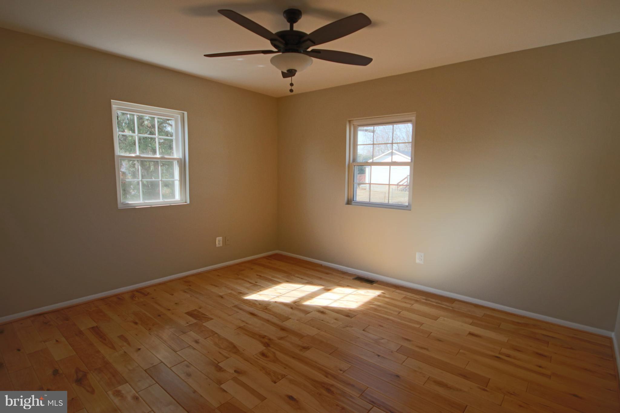 215 Kenwood Road Pasadena, MD 21122 - Photo 8 of 22 Bedroom w/wood floors & ceiling fan