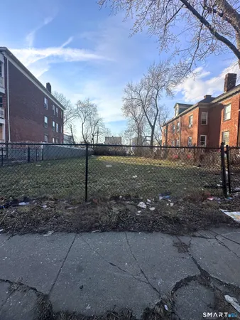 a backyard of apartments with large trees