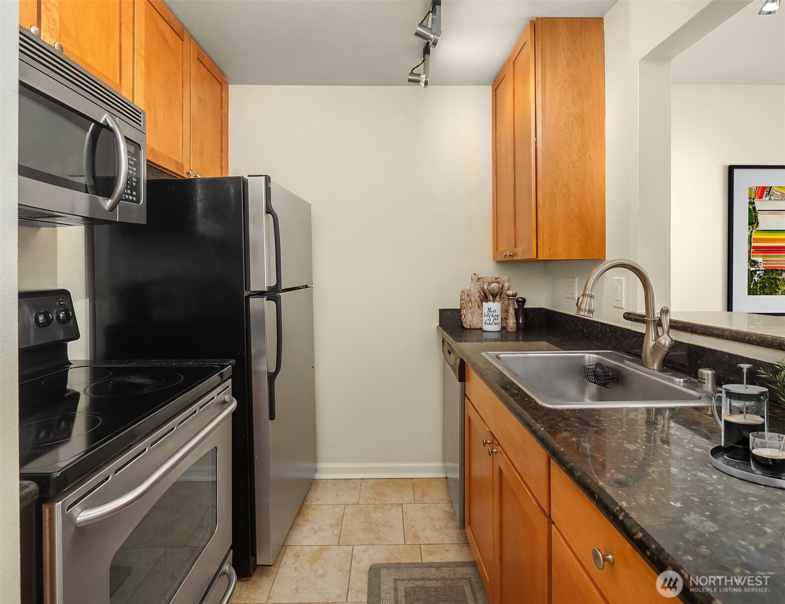 3636 Evanston Avenue North, Unit 12 Seattle, WA 98103 - Photo 7 of 17 a kitchen with stainless steel appliances granite countertop a sink stove and refrigerator