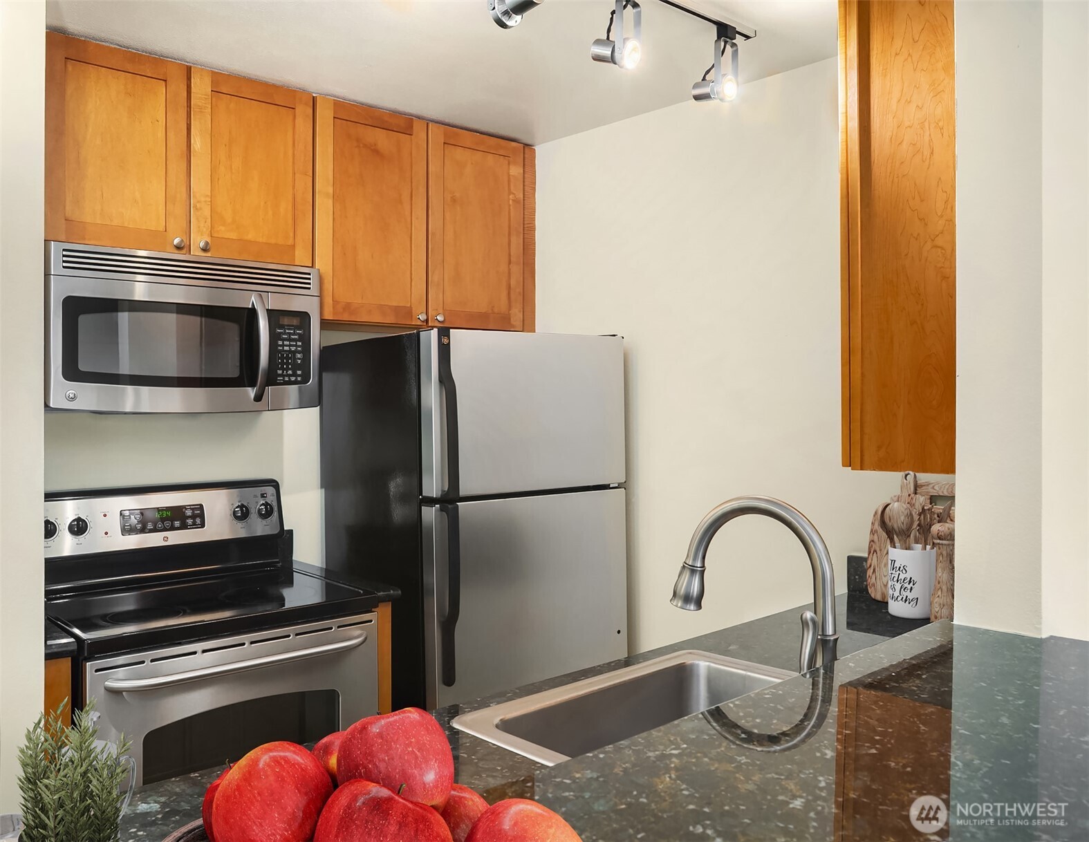 3636 Evanston Avenue North, Unit 12 Seattle, WA 98103 - Photo 8 of 17 a kitchen with a appliances a sink and cabinets