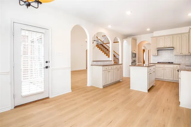 a kitchen with stainless steel appliances granite countertop a sink stove and cabinets