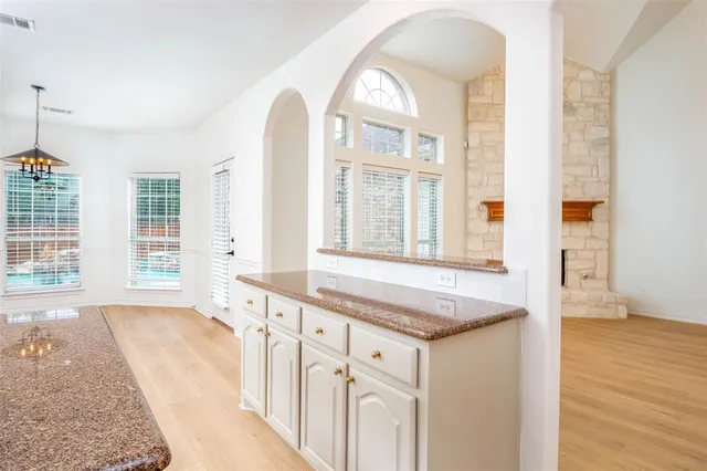 an empty room with chandelier fan and closet