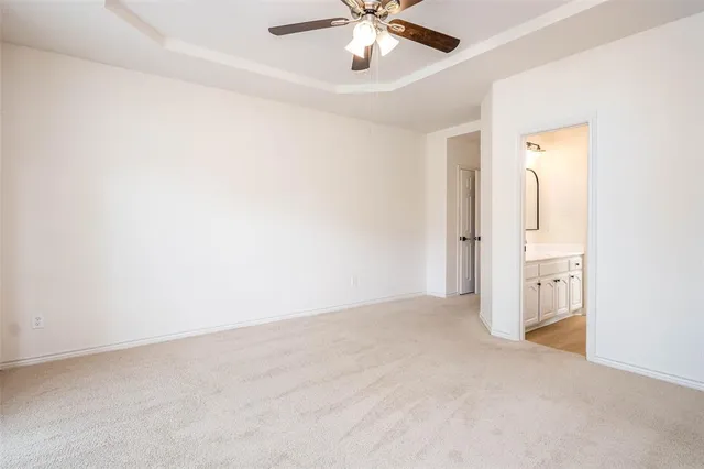 an empty room with chandelier fan