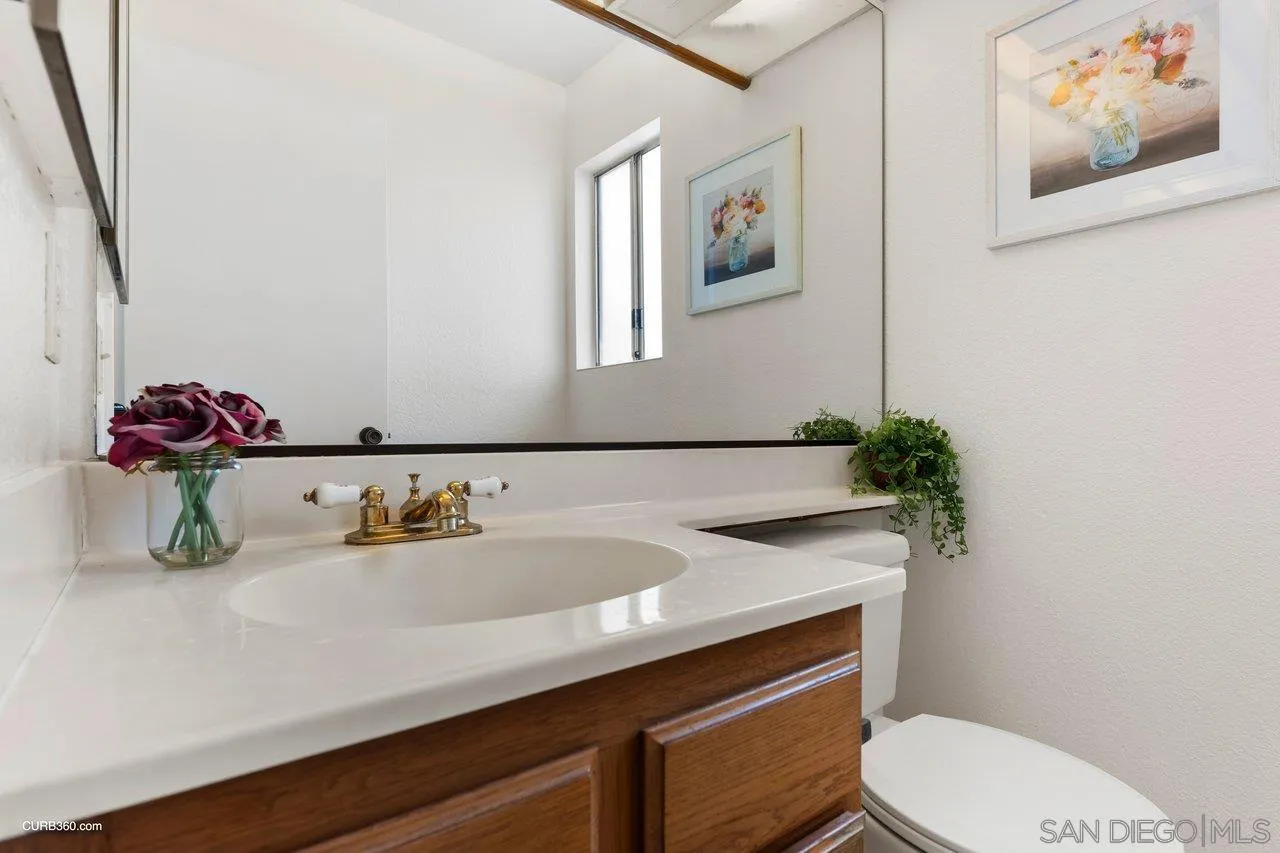 1373 Crestview Drive Oceanside, CA 92056 - Photo 15 of 33 a bathroom with a sink toilet and mirror