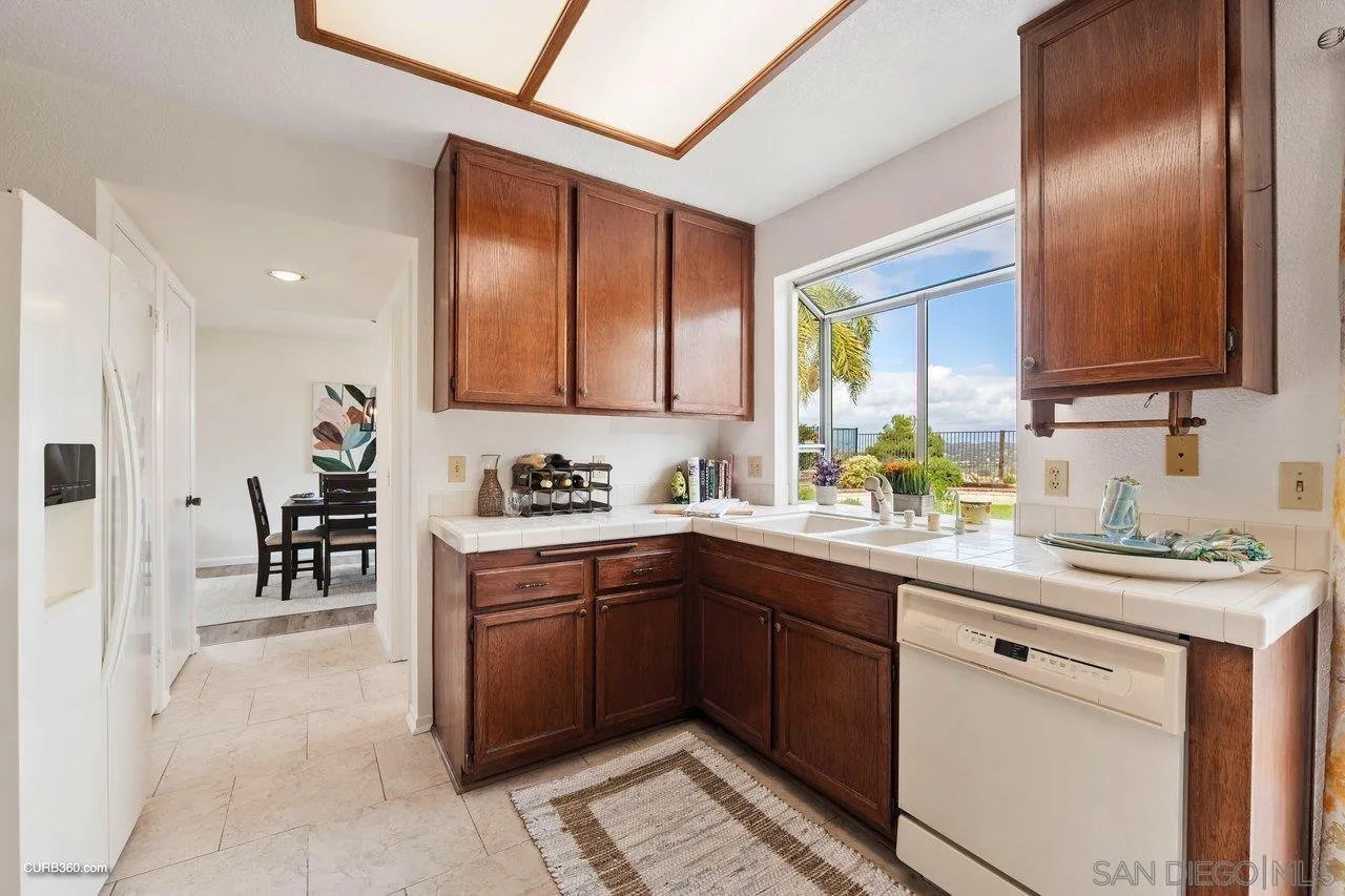 1373 Crestview Drive Oceanside, CA 92056 - Photo 17 of 33 a kitchen with a sink stove and cabinets