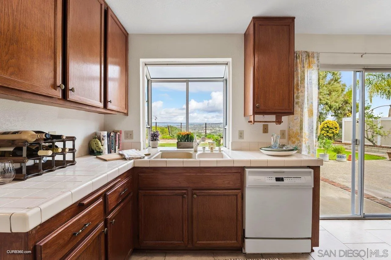 1373 Crestview Drive Oceanside, CA 92056 - Photo 19 of 33 a kitchen with stainless steel appliances granite countertop a sink and a stove