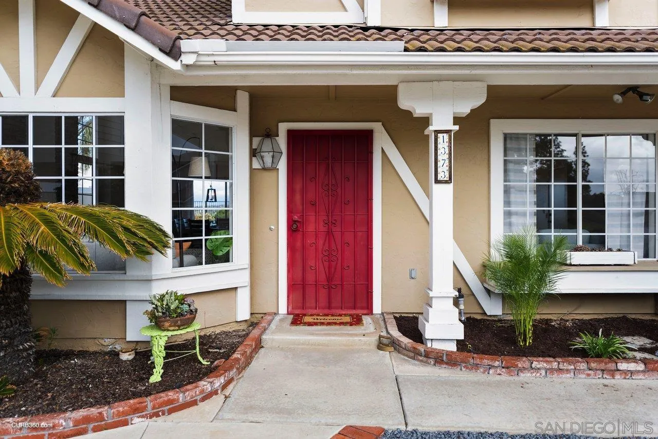 1373 Crestview Drive Oceanside, CA 92056 - Photo 6 of 33 a front view of a house with a yard and garage