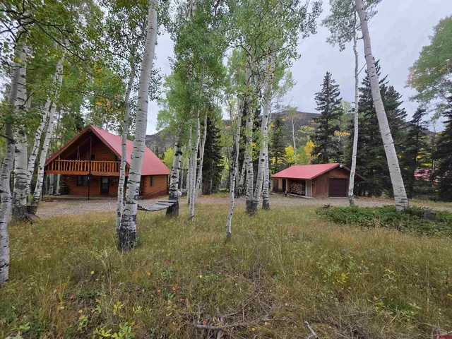 a backyard of a house with table and chairs