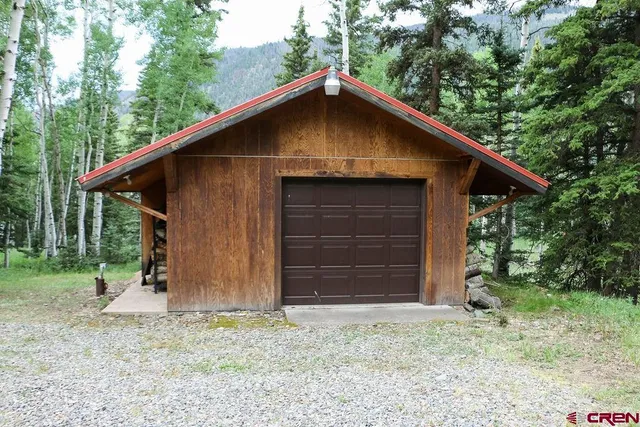 a backyard of a house with barbeque oven and outdoor seating