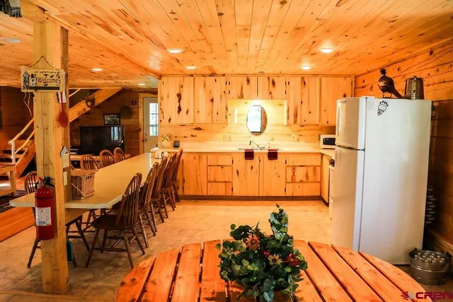 a view of a patio with table and chairs with wooden floor