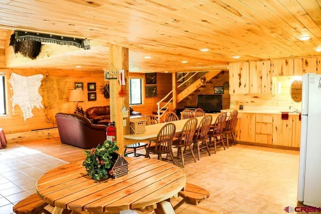 a living room with furniture stove and wooden floor