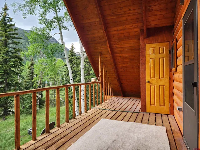 a view of a balcony with a table and chairs