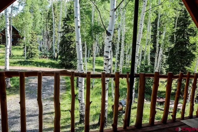 a bathroom with a toilet and a shower curtain