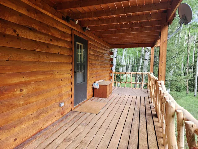 a view of a house with a yard and tree s