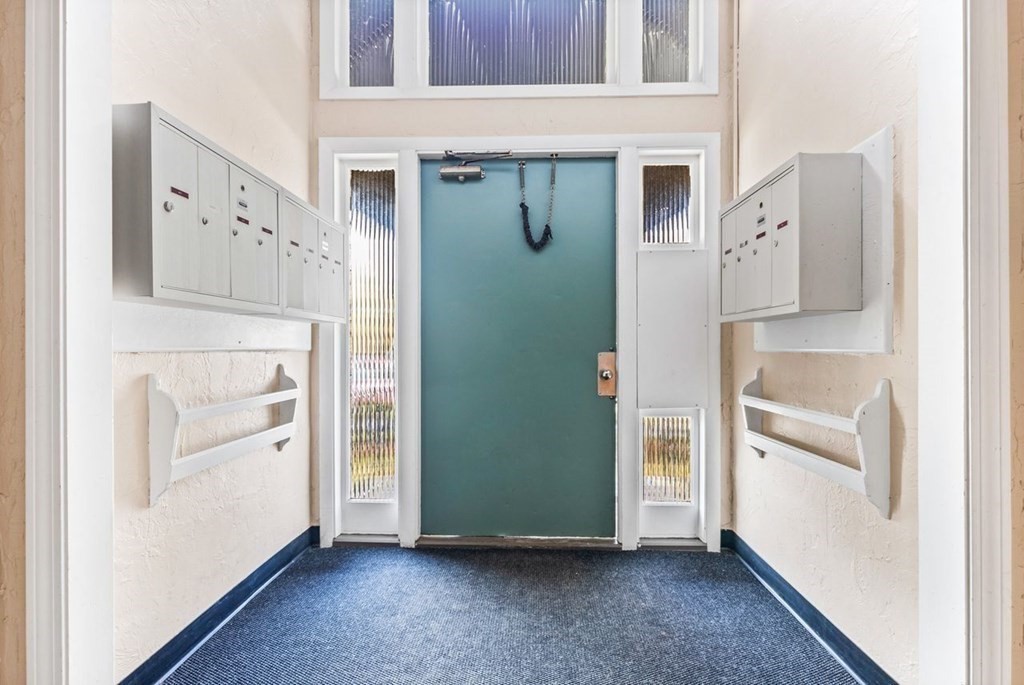 80 Walnut Street, Unit 410 Canton, MA 02021 - Photo 4 of 21 a view of a kitchen with white cabinets and refrigerator