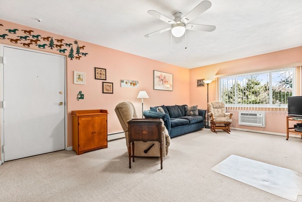 80 Walnut Street, Unit 410 Canton, MA 02021 - Photo 7 of 21 a living room with furniture and a large window