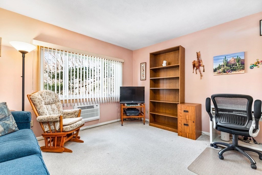 80 Walnut Street, Unit 410 Canton, MA 02021 - Photo 9 of 21 a bedroom with furniture and a window