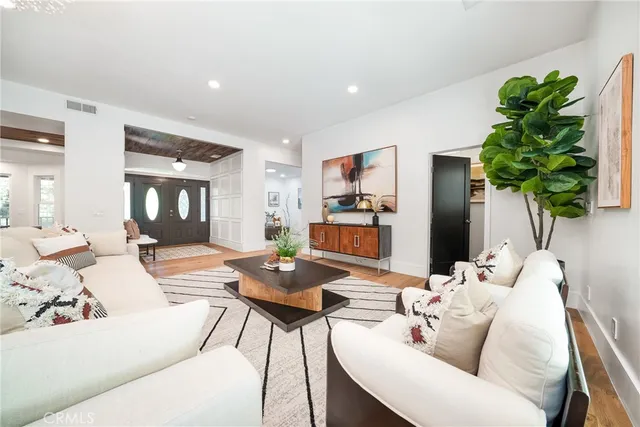 a living room with furniture and a potted plant