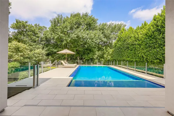 a view of a swimming pool with a yard