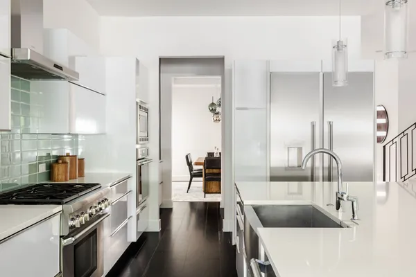 a kitchen with granite countertop a sink and stove top oven