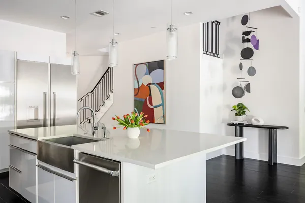 a kitchen with stainless steel appliances and wooden floor